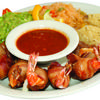 Costa Azul is a plate with cheese-filled shrimp wrapped in bacon with a side of specially made dipping salsa. Sides of rice, beans, and guacamole, and tortillas included.